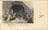 1913 Ratsversammlung vor der Hütte des Sultans / African folklore, council meeting in front of the Sultan's hut (Rb)